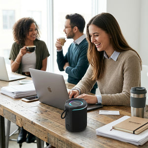 Sharp GX-BT190-BK portable speaker with LED lighting on an office desk with professionals.
