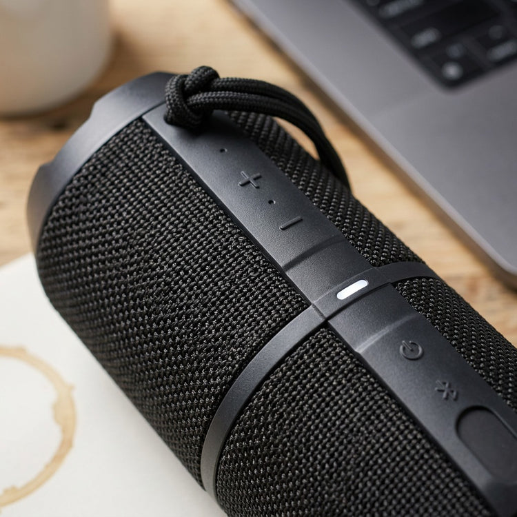 Macro detail of the Sharp GX-BT290-BK speaker controls, durable mesh, and black carry strap.