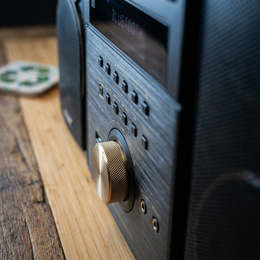 Macro detail of Sharp XL-BH250GL micro shelf system showing knurled volume knob and carbon finish.